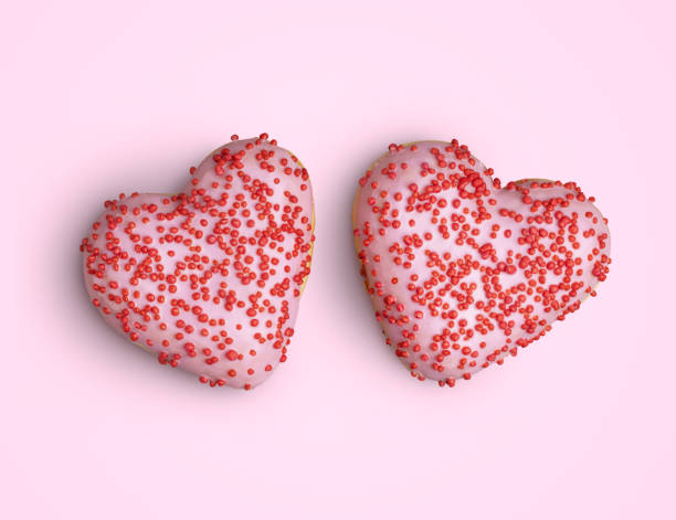 istock Heart doughnuts with sprinkles on pink 1220558798