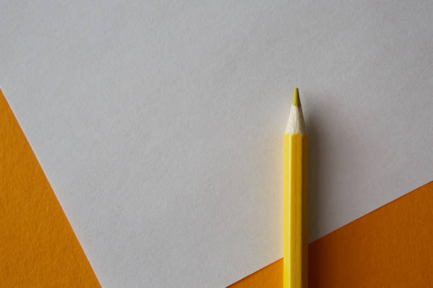 istock Yellow colored pencil lying on a yellow and white background 1220559404