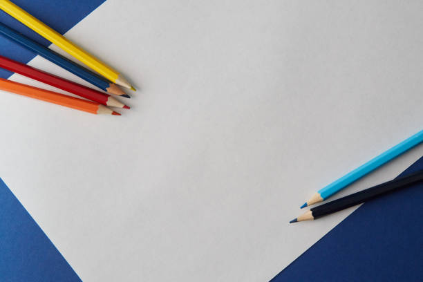 istock Several colored pencils of various shades lie on a bright blue and white background 1220559569