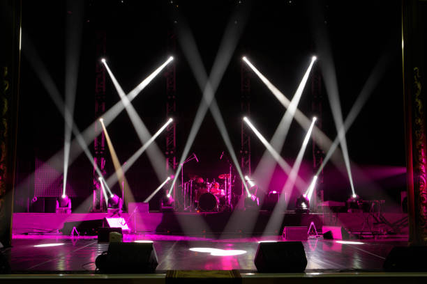 istock scene, stage light with colored spotlights and smoke 1220559980