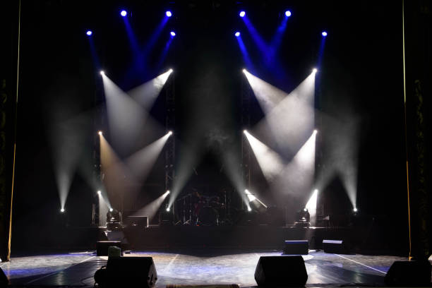 istock scene, stage light with colored spotlights and smoke 1220559998