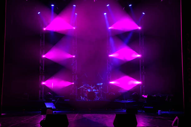 istock The light of searchlights in smoke on stage. 1220560105