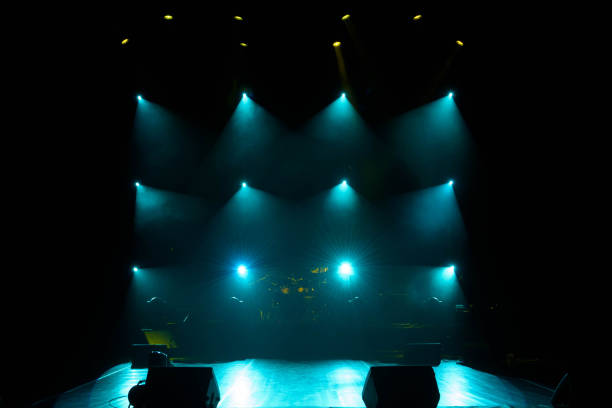 istock The light of searchlights in smoke on stage. 1220560149