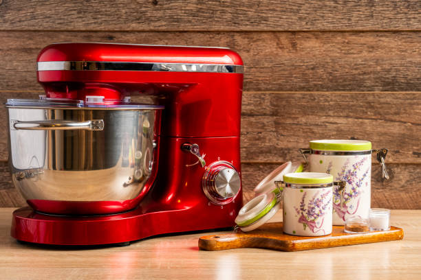 istock Locked stand mixer and two container jars for flour and sugar on a chopping board 1220564145
