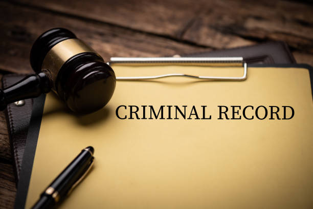 Criminal Record text on Document and gavel isolated on wooden office desk stock photo