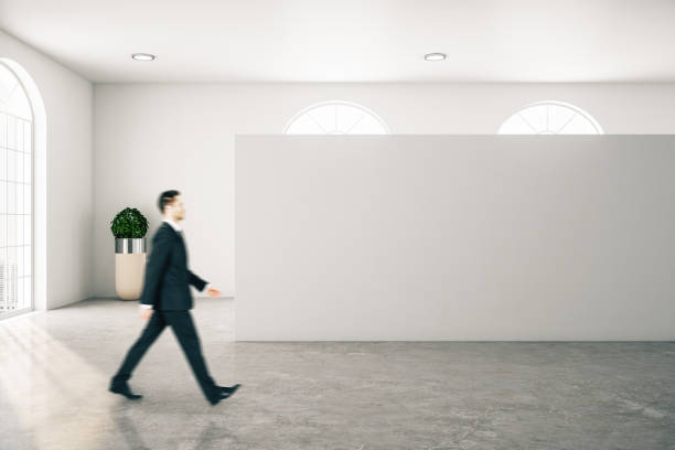 istock Businessman walking in contemporary gallery interior 1220566812