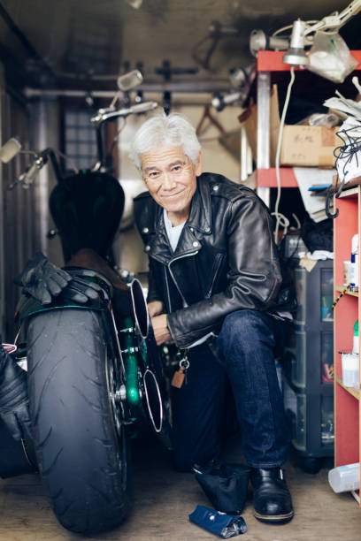 istock Happy Senior Man Repairing a Motorcycle 1220568242
