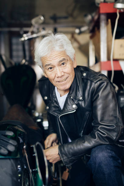 istock Happy Senior Man Repairing a Motorcycle 1220568371