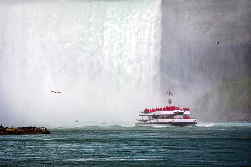 tourist boat in the mist under Horseshoe Falls on the Niagara River