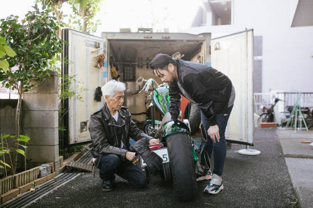 istock Father and Son Repairing Motorcycle together 1220568703