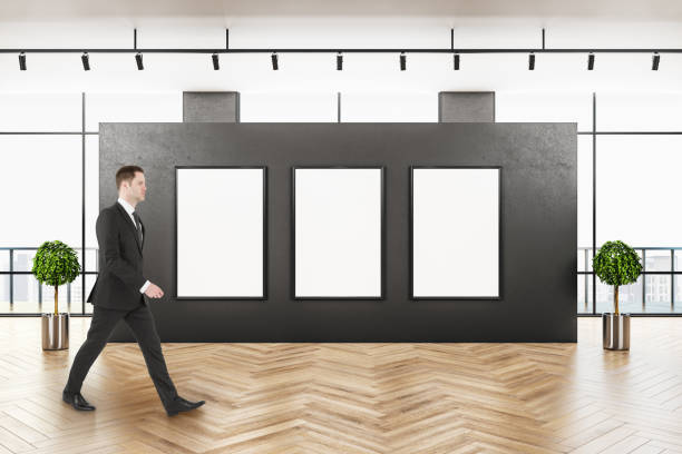 istock Businessman walking in contemporary gallery interior 1220569287