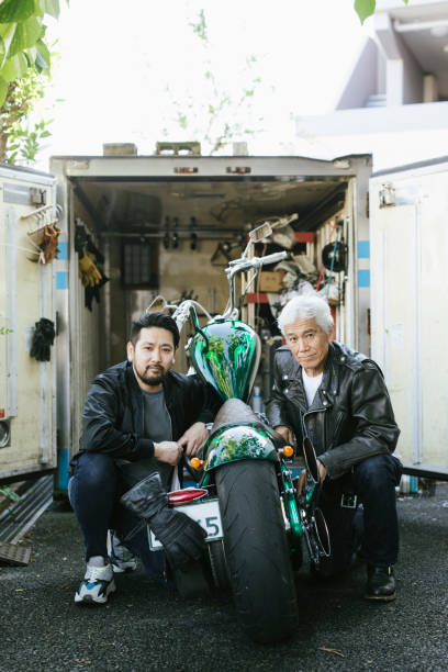 istock Father And Son With a Motorcycle In Front Of A Small Garage 1220569938
