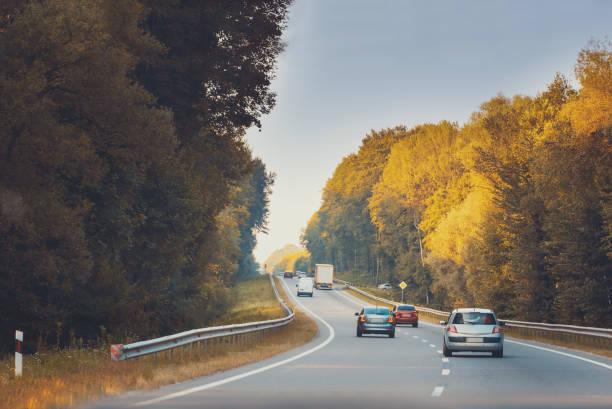 istock Traffic in high speed on a highway through rural landscape on sunset. 1220572938