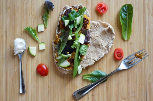 Traditional homemade falafel in pita and salad on a chopping Board. Jewish and Arabic vegetarian cuisine.