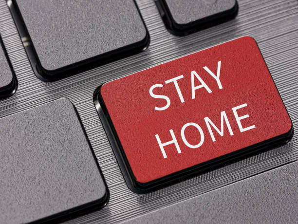 istock Close up Stay home key on computer keyboard warning message concept 1220574194