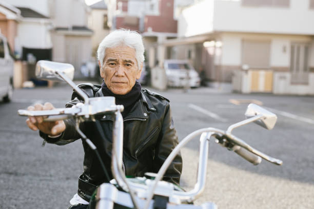 porträt von senior moto enthusiast - men hat leather senior adult stock-fotos und bilder