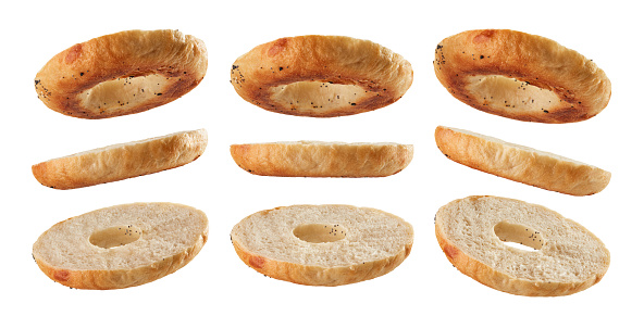 Halved bagel bottoms levitating in different positions isolated on white background