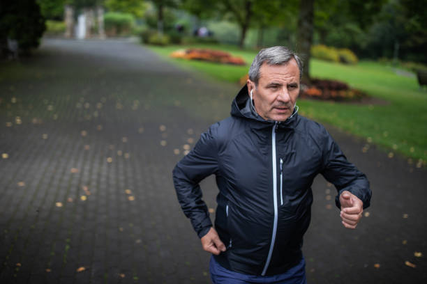 istock Mature man running alone in public park during  autumn morning 1220575073
