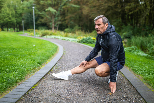 istock Man stretching at public park early in the morning 1220575218
