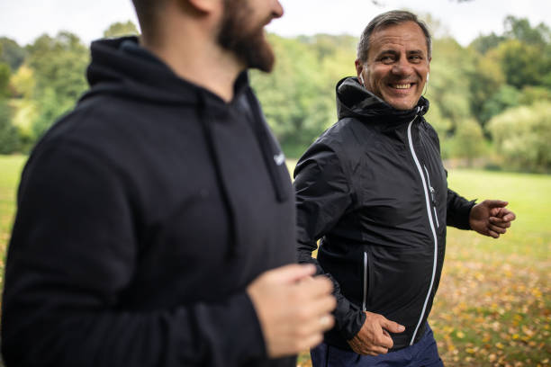 istock Father and son jogging together at public park 1220575304