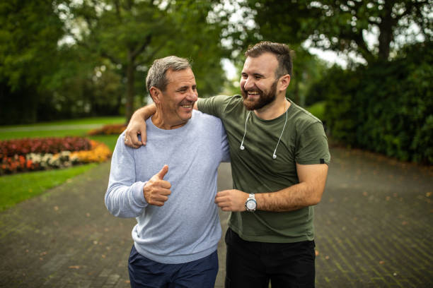 istock Father and son spending active weekend morning together at public park 1220575429