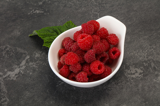 Red bright ripe sweet raspberry with leaf