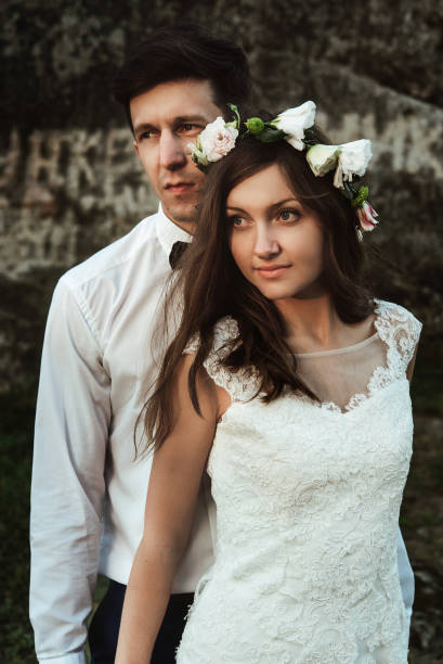 istock happy elegant groom and  stylish boho bride posing at sunset in the mountains 1220579866