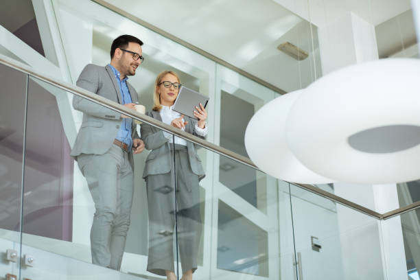 istock Business people using digital tablet in modern office corridor 1220581013