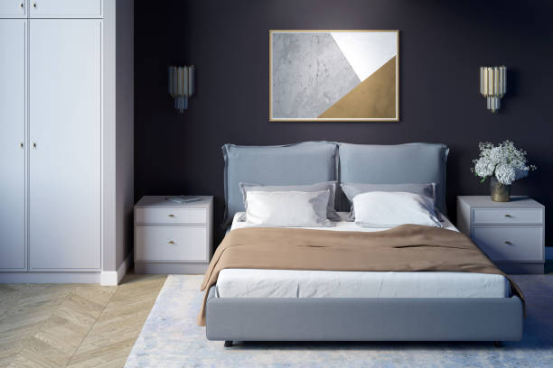 istock A cozy bedroom with a horizontal poster on a dark wall. A bed with a beige blanket between two nightstands, next to a wardrobe. Front view. 1220581450