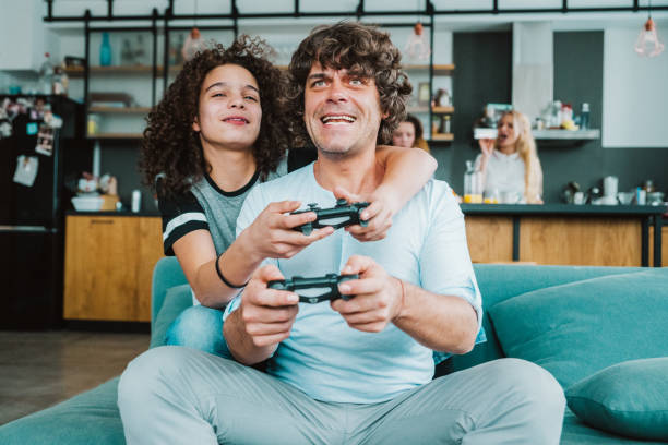 istock Father and son playing digital games at home 1220581474