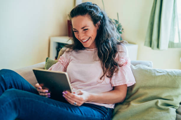 istock Beautiful woman using tablet at home. 1220581548