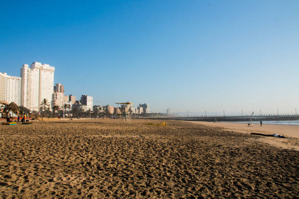 istock Footprints in Beach Sand Pier and Hotels in Background 1220581853