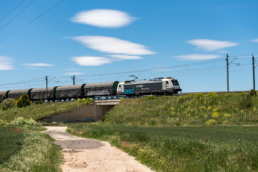 A cargo train passes through the landscape outside Tardajos, near the city of Burgos, Spain