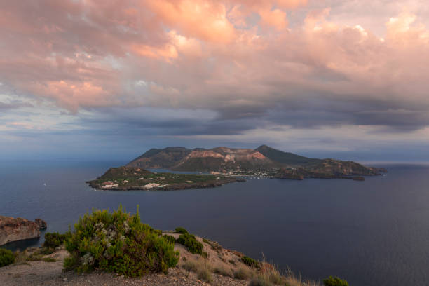 istock View to volcano island Vulcano from Lipari with dramatic clouds in the sky during sunset, Sicily Italy
