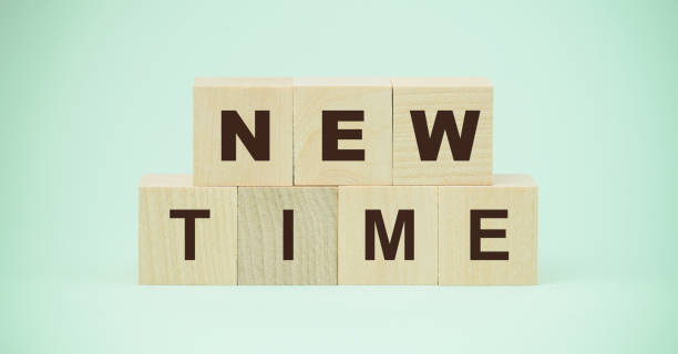 istock new time words on wooden blocks isolated on blue background 1220583640