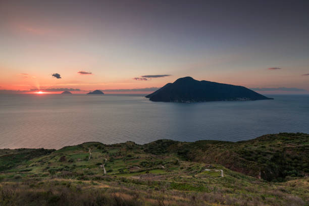 Coast of Lipari with view to volcano islands Salina, Alicudi, Filicudi during sunset, Sicily Italy"n Coast with grass fields of Lipari with view to volcano islands Salina, Alicudi, Filicudi during sunset, Sicily Italy"n filicudi stock pictures, royalty-free photos & images