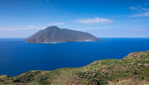 Coast of Lipari with view to volcano islands Salina, Alicudi, Filicudi during day, Sicily Italy"n Coast with grass fields of Lipari with view to volcano islands Salina, Alicudi, Filicudi during blue sky day, Sicily Italy"n filicudi stock pictures, royalty-free photos & images