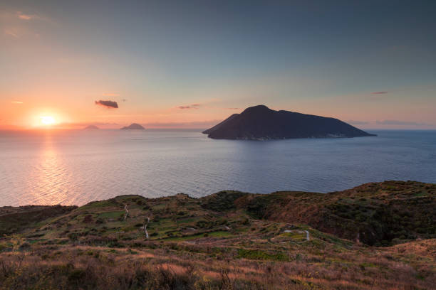 Coast of Lipari with view to volcano islands Salina, Alicudi, Filicudi during sunset, Sicily Italy"n Coast with grass fields of Lipari with view to volcano islands Salina, Alicudi, Filicudi during sunset, Sicily Italy"n filicudi stock pictures, royalty-free photos & images