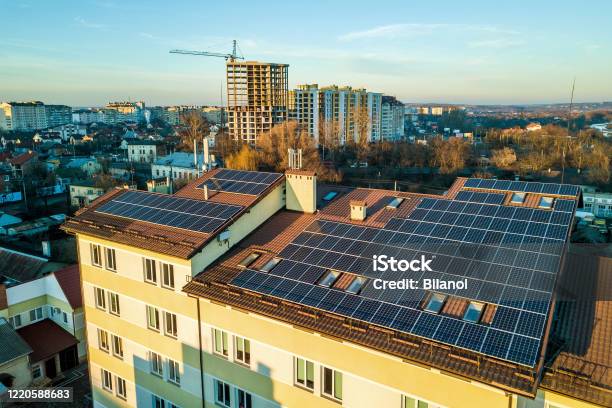 Aerial View Of Many Photo Voltaic Solar Panels Mounted Of Industrial Building Roof Stock Photo - Download Image Now