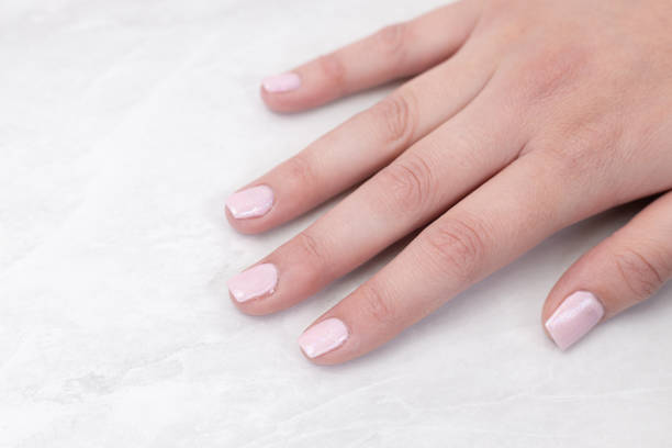 istock Woman hand with beautiful colored nails with copy space. 1220589615