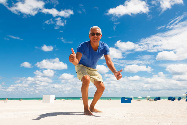 handsome man at the beach - one person beautiful barefoot beach fotografías e imágenes de stock