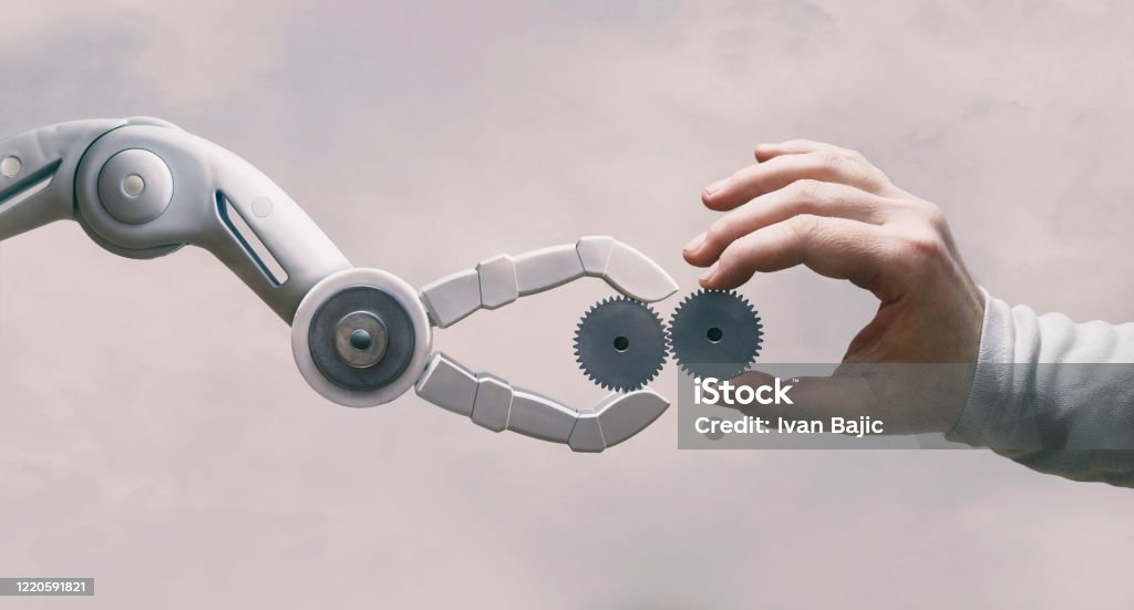 Robot And Human Hand with Gears Robot and human working together. Robot Stock Photo