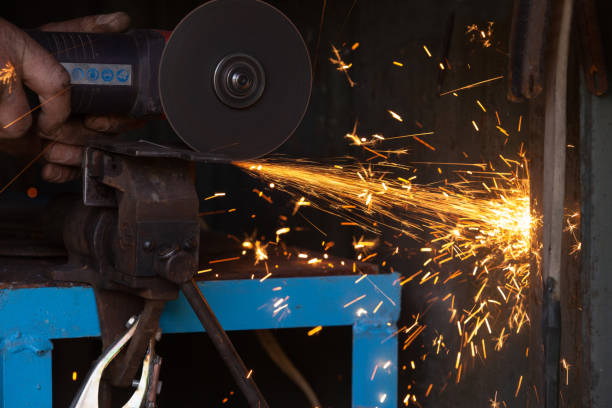 istock Worker cuts metal with an electric hand tool 1220592120
