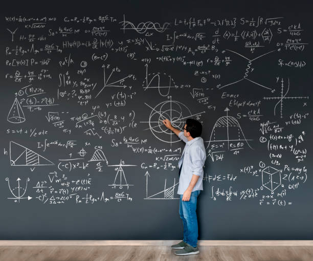 Math teacher writing formulas on a blackboard Math teacher writing formulas on a blackboard - complex mathematics concepts writing on chalk board stock pictures, royalty-free photos & images
