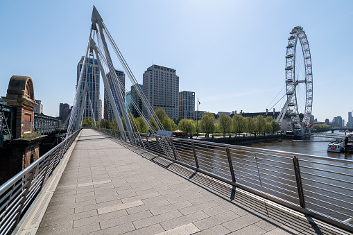 London, UK - April 23rd 2020:  Empty pedestrian bridge on river Thames in central London during lockdown