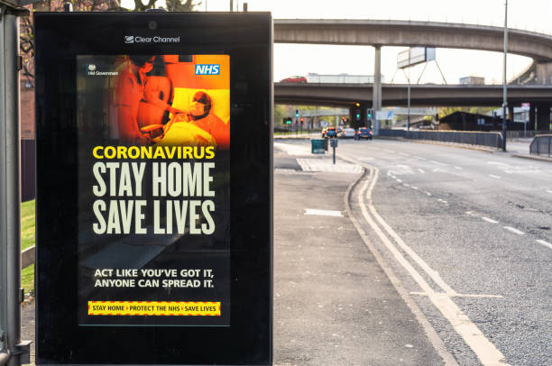 stay home save lives sign during coronavirus lockdown measures - billboard symbol city street imagens e fotografias de stock