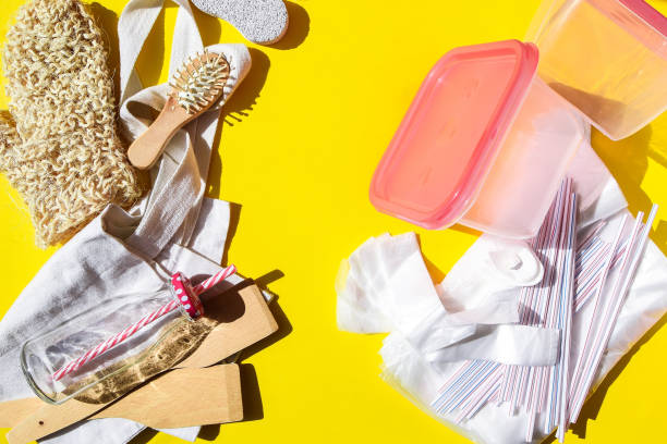istock Zero waste eco friendly reusable objects such as reusable linen shopping bags, glass jars and wooden hairbrush vs plastic single-use objects 1220598297