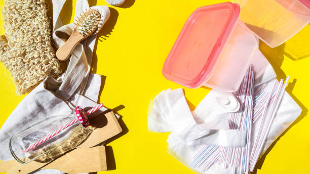istock Zero waste eco friendly reusable objects such as reusable linen shopping bags, glass jars and wooden hairbrush vs plastic single-use objects 1220598316