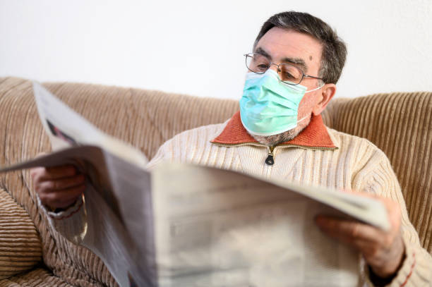 istock Elderly man reading newspaper during coronavirus epidemic quarantine. 1220598953