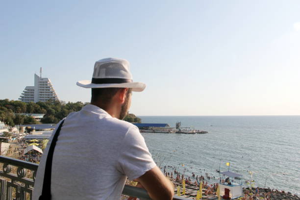 istock A man in a white hat on the beach 1220601057